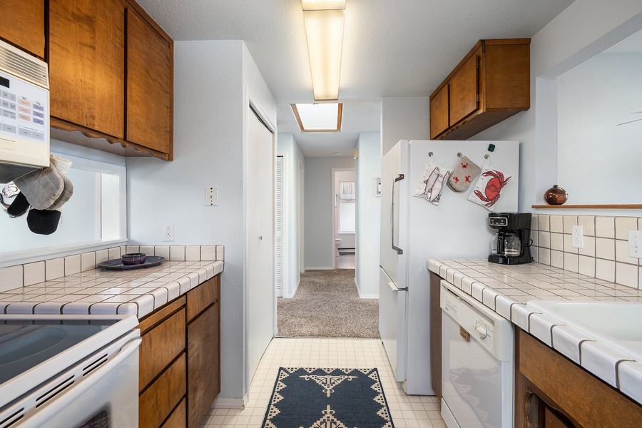 Pass through the hall from the dining area to the fully-stocked kitchen.