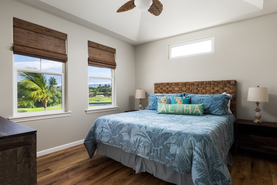 This spacious primary bedroom has scenic views of the fairway and mountains
