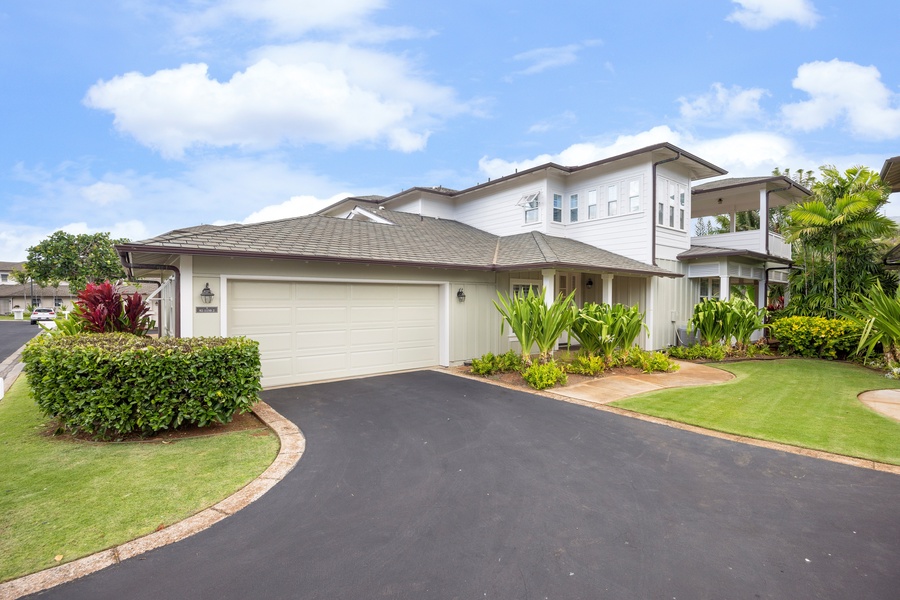 A beautifully landscaped vacation home with tropical gardens and modern architecture in a peaceful residential setting.