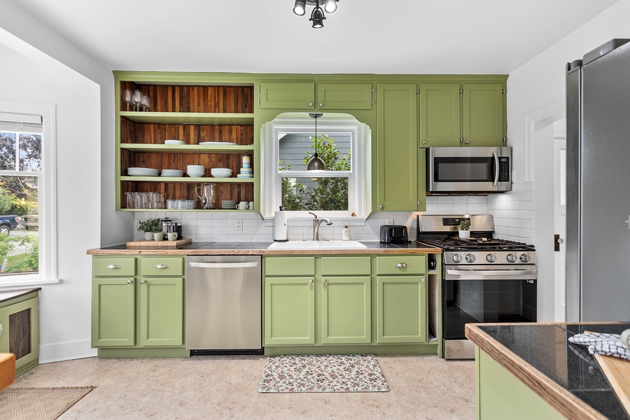 The spacious kitchen features stainless steel appliances, a gas stove, and plenty of prep space for your culinary needs.