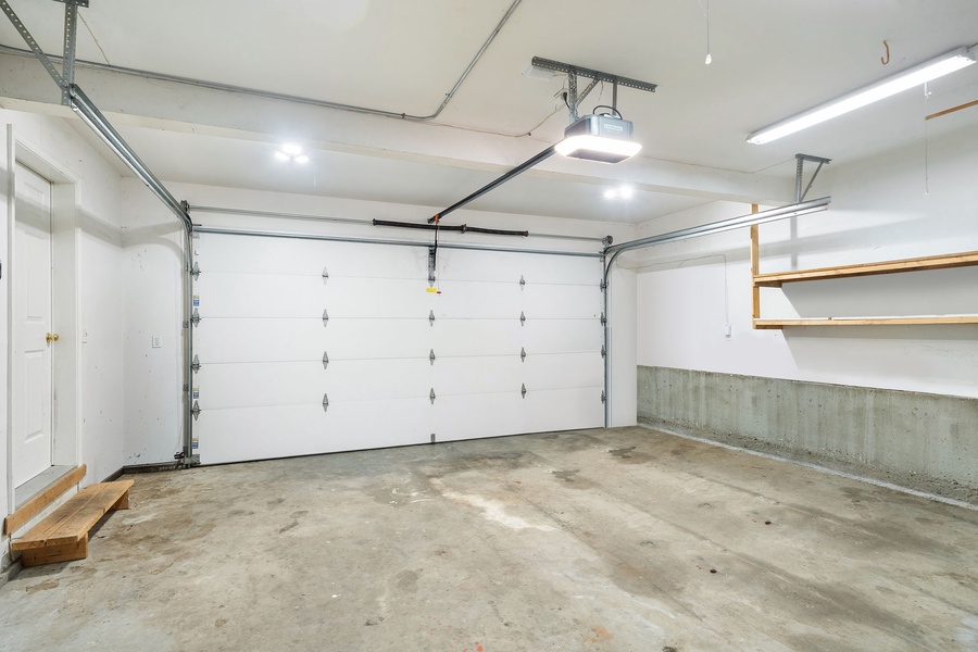 Spacious garage with automatic door opener provides secure parking and convenient storage for your vehicle and belongings.
