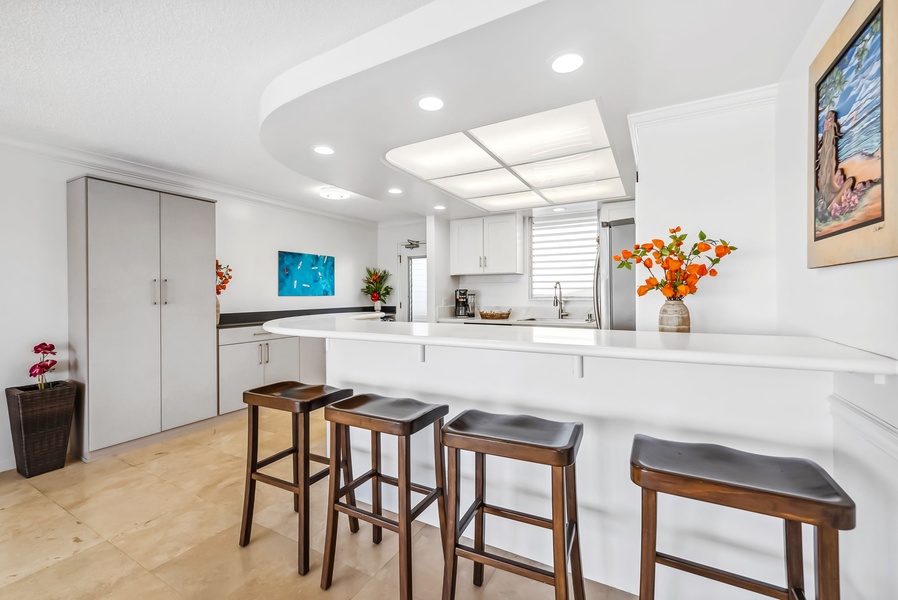 Open-concept kitchen with bar seating and natural light—ideal for dining or socializing.