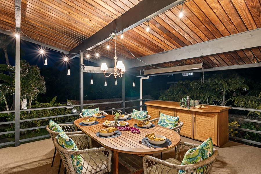 Gather around this tropical dining terrace where warm evenings unfold beneath string lights and stars, surrounded by lush gardens.