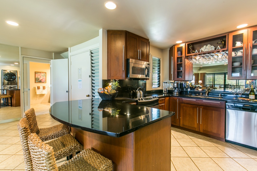 Conveniently prep meals in the fully equipped kitchen with bar seating for three. – A great spot for casual breakfasts or chats while cooking.
