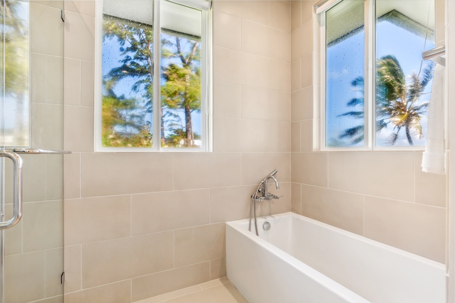 Luxurious soaking tub illuminated by natural light, perfect for unwinding.