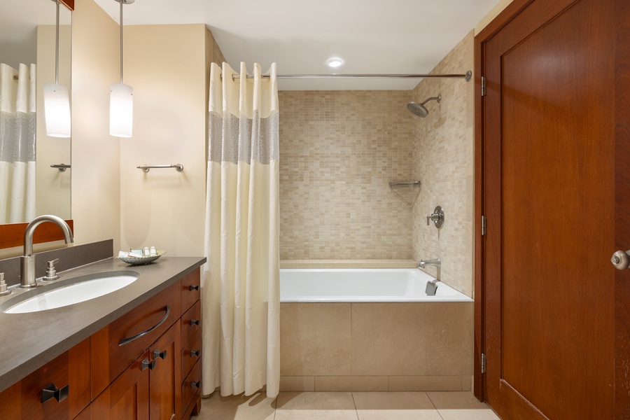 The second guest bathroom with a shower and tub combo.