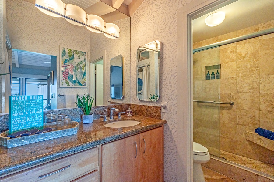 Elegant bathroom with granite countertops and a spacious walk-in shower.