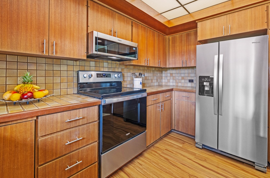 This modern kitchen is fully equipped with stainless steel appliances, sleek cabinetry, and ample counter space