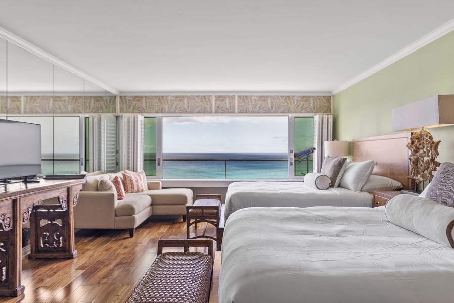 Breathtaking ocean views from your cozy bedroom, complete with seating area and serene decor for ultimate relaxation.