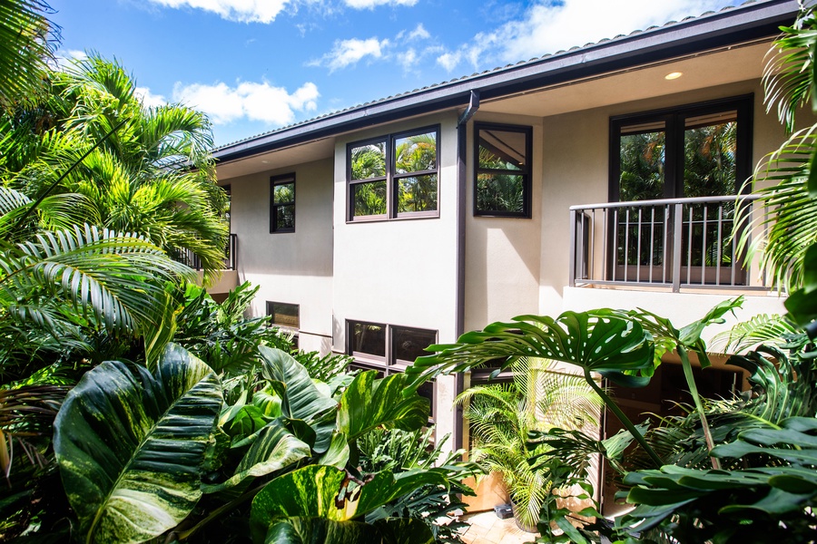 Rear exterior showcasing lush tropical landscaping.