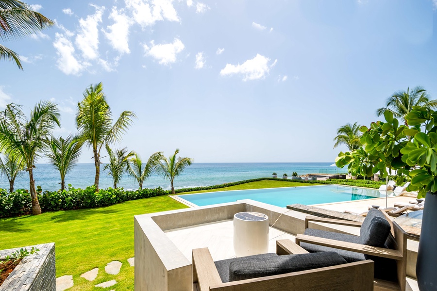 Relax on the private terrace with plush seating, overlooking the infinity pool and stunning ocean views.