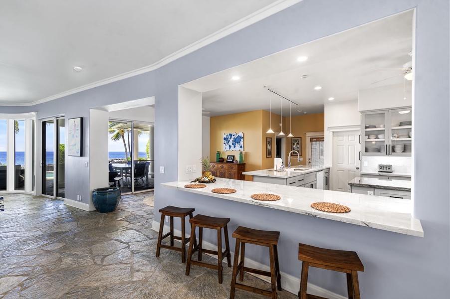Gourmet kitchen with soaring ceilings, abundant storage, and expansive island seating.