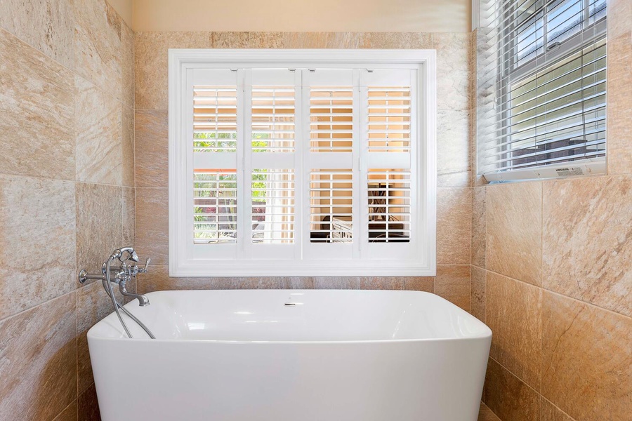 Enjoy a relaxing soak in the large bathtub.