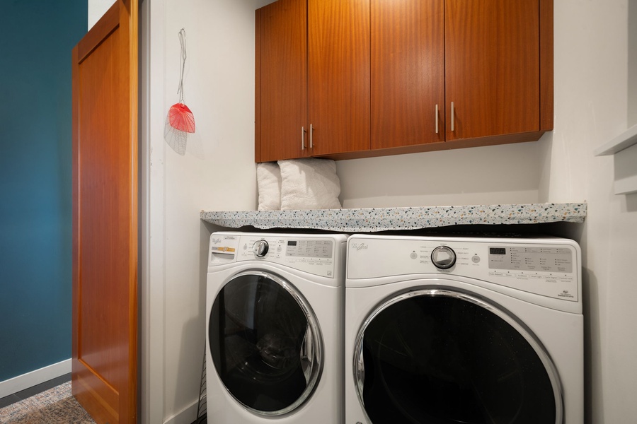 Your dedicated laundry room features modern washer and dryer with ample storage above for all your travel essentials.