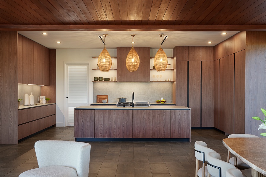 Chef’s kitchen with large island, pendant lighting, and high-end appliances.