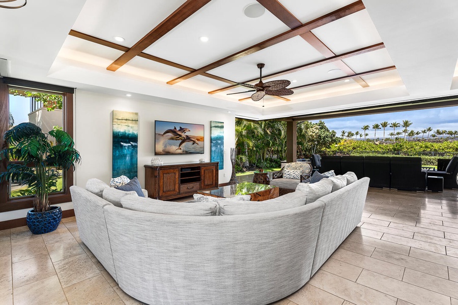 Spacious open-concept living with panoramic views and lanai access.