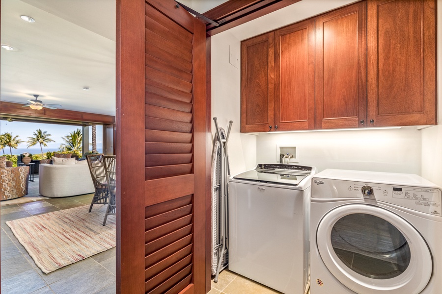 Dedicated laundry room with top tier washer/dryer and provided laundry detergent