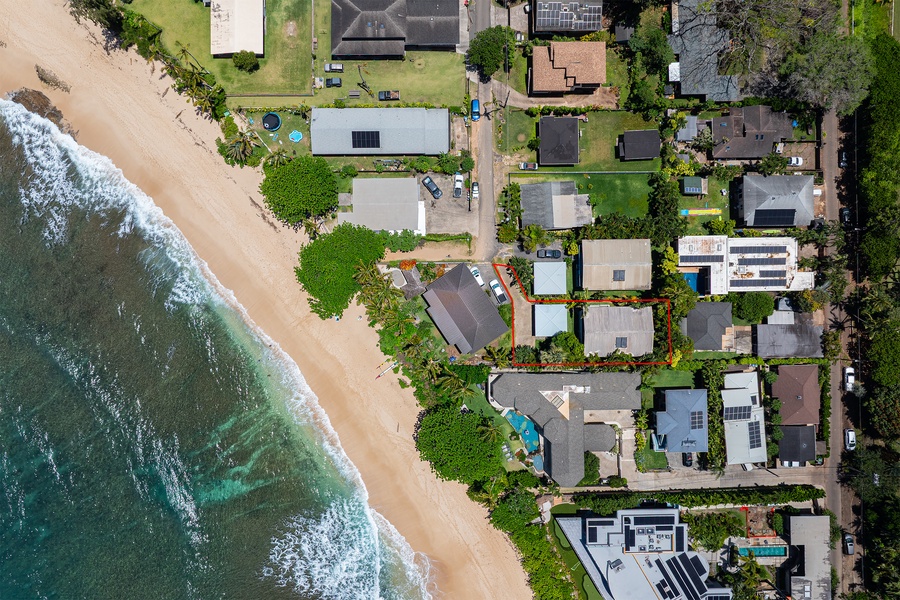 Aerial views showcase the home’s prime location just steps from the shoreline.