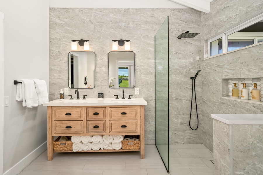 The stylish bathroom offers a modern, spa-like ambiance with ample space to unwind.