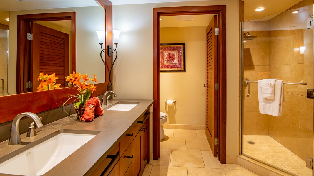 The primary guest bath features a double vanity and privacy door.