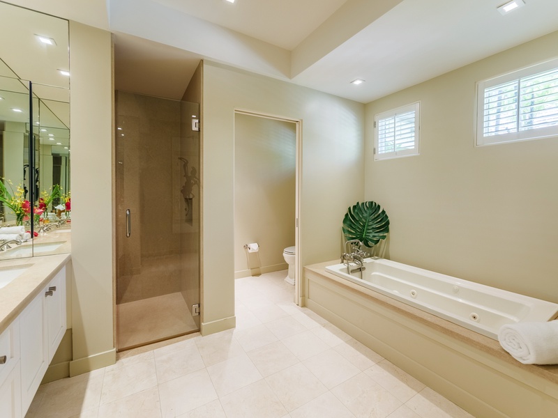 Dive into luxury in the expansive ensuite bathroom, complete with a sumptuous tub for long soaks and a walk-in shower for invigorating refreshment.