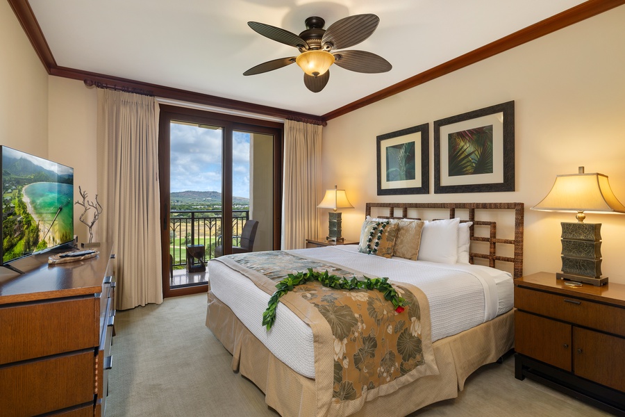 The primary suite is furnished with a king bed, private lanai with golf course view, walk-in closet, dual sinks, and a separate tub and shower.