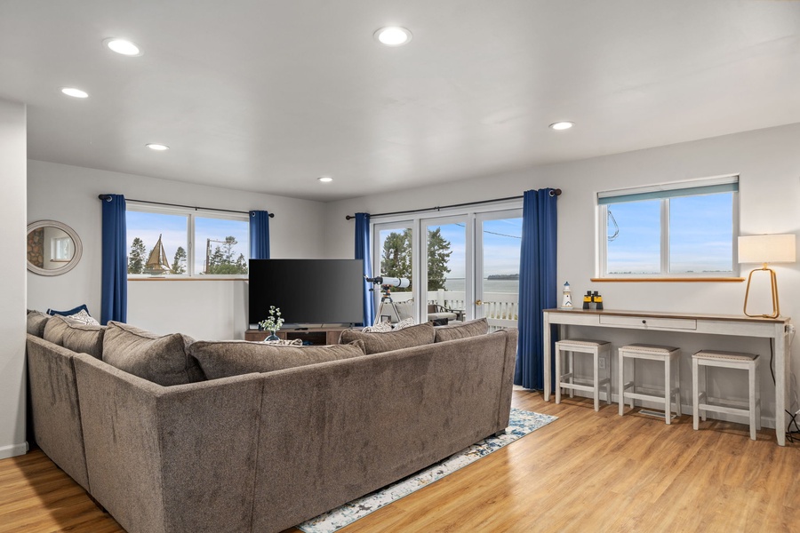 Settle into this bright living space where panoramic windows frame stunning views and comfortable seating invites you to unwind completely.