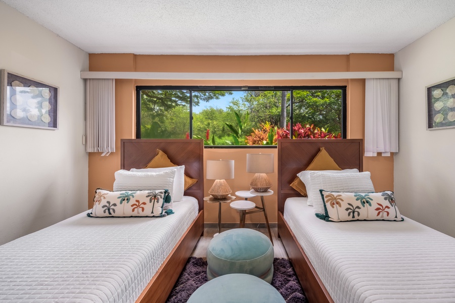 Wake up to lush tropical views through your bedroom window, where twin beds offer comfort and vibrant garden scenes greet you each morning.