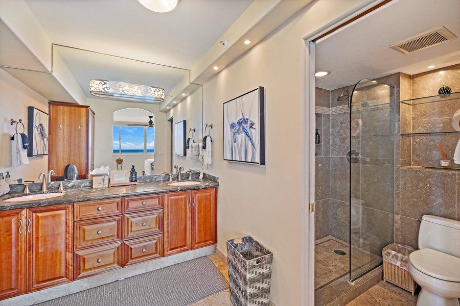 The primary bathroom at Royal Kahana 610 features a spacious vanity and a walk-in shower for a refreshing start to your day.