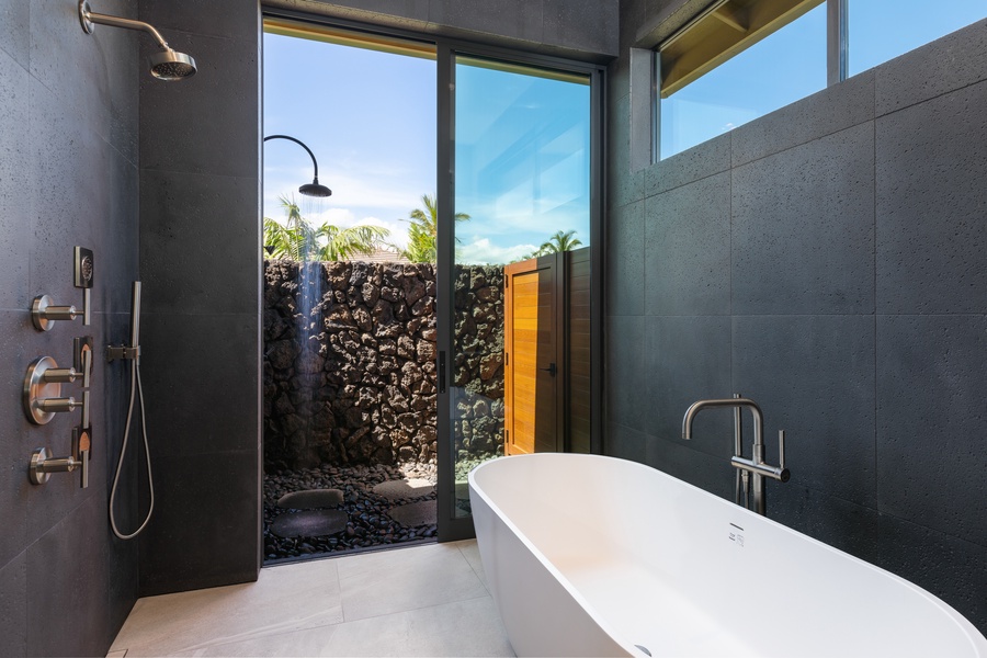 The spa-like downstairs primary ensuite (Bathroom 3) has a large soaking tub and an outdoor shower.
