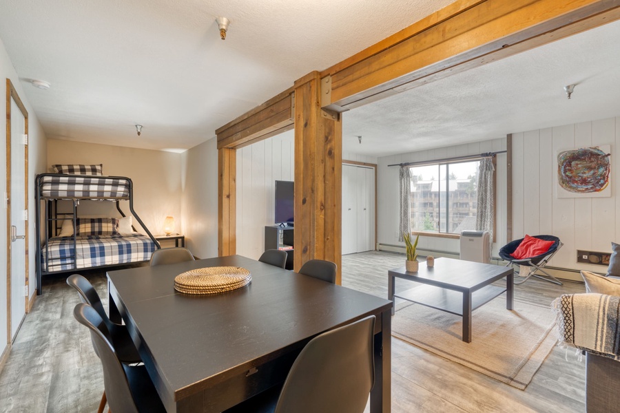 There is a coffee table and a 55” Smart screen TV in the main area as plenty of light flows in from the large window, creating a welcoming ambiance perfect for entertaining and enjoying the shared company