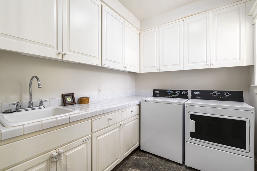 Large laundry room with commercial-grade washer and dryer for extended stays.