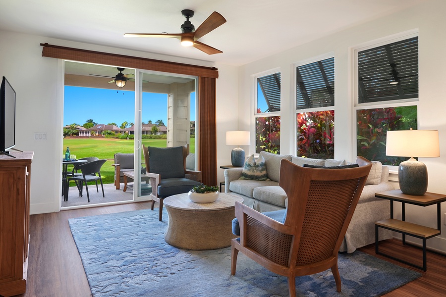 Bright living room opens to the lanai with sliding doors, blending indoor comfort and outdoor ease.