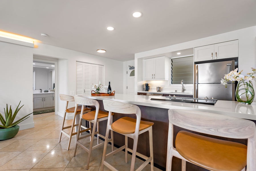 Casual breakfasts or happy hour bites feel elevated at this oversized kitchen island—complete with bar seating and ambient lighting.