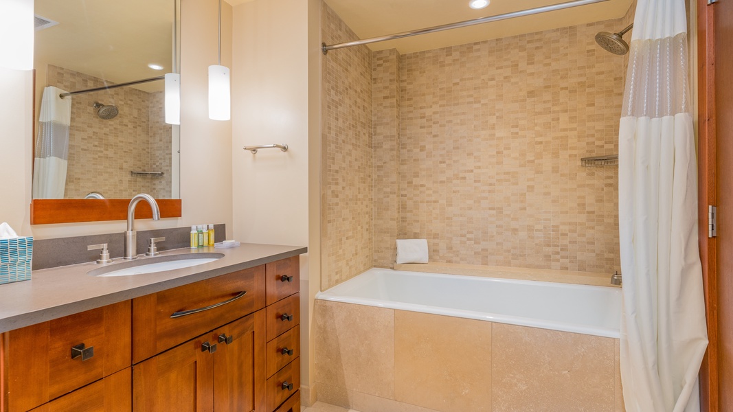 The second guest bathroom has a shower- tub combo.