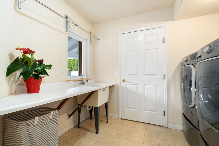 Your dedicated laundry room features a spacious sink for hand-washing delicates and modern appliances to keep your clothes fresh during your stay.