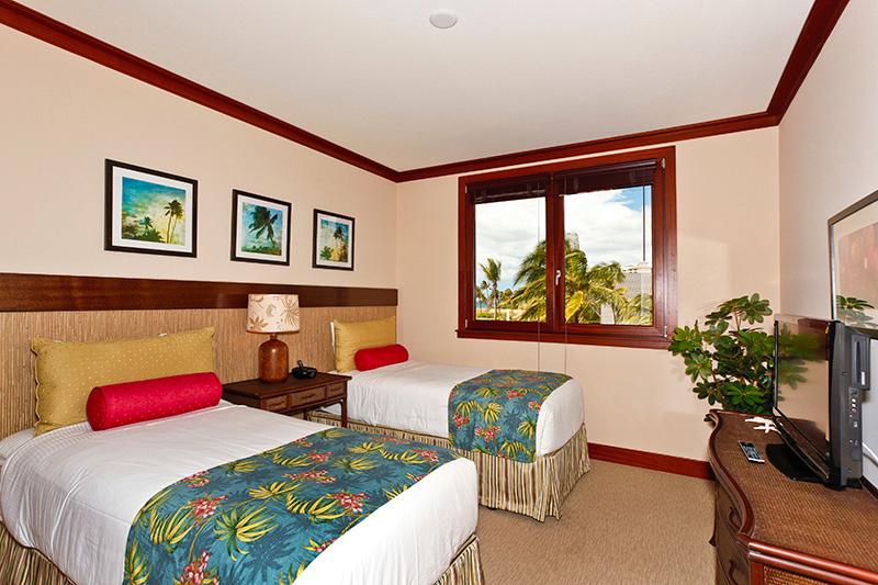 The second guest bedroom features twin beds and colorful accents.