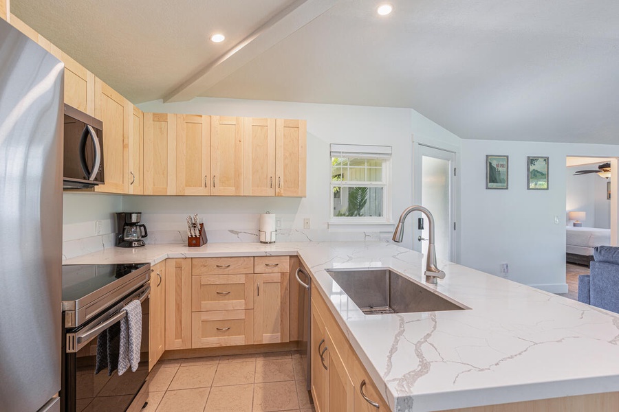 Well-equipped kitchen with natural wood cabinetry and full amenities.
