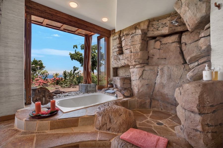 Retreat suite bath with ocean-view soaking tub and walk-in rock shower.