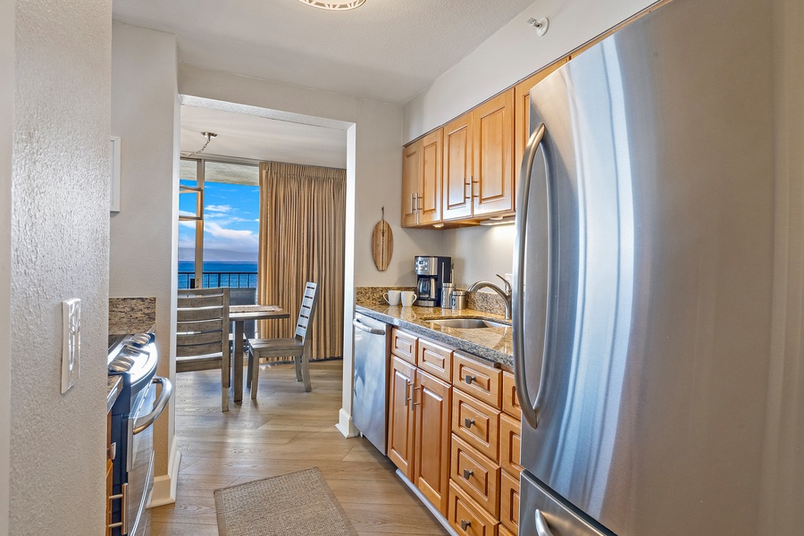 The fully equipped kitchen features stainless steel appliances and granite countertops, providing everything you need