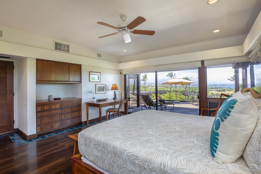 Luxurious king bed with island-inspired decor and sliding doors leading to a private retreat.