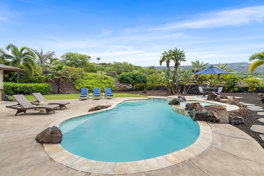 Dive into serenity, where the pool meets nature's embrace.