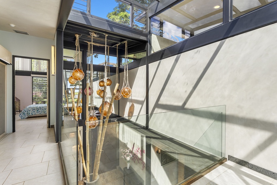 A striking architectural staircase with glass railings and stunning natural light.