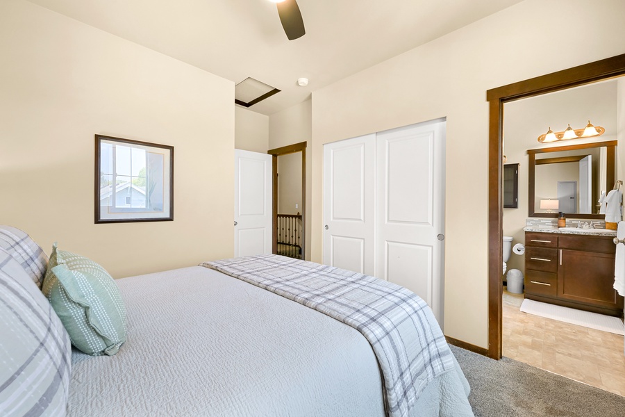 This bright and airy guest room includes closet space and direct access to its own full bath.