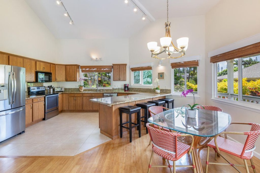 The kitchen features an island_bar for entertainment, and a breakfast nook with a glass table