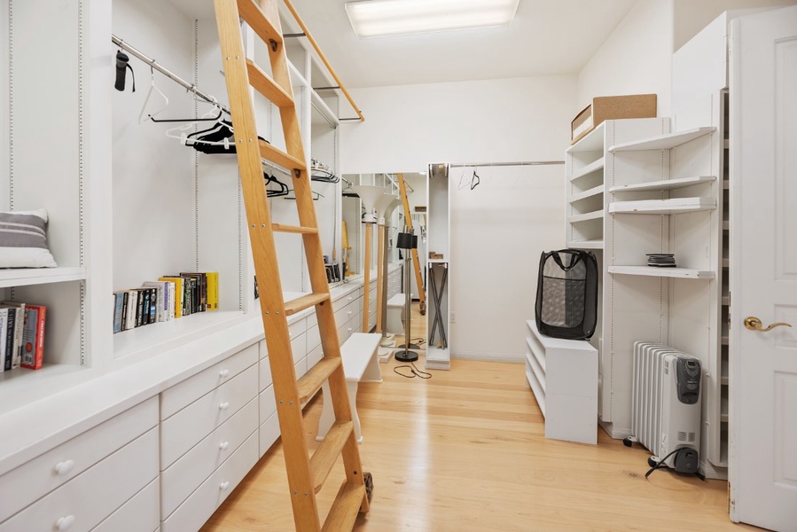 Primary massive walk in closet with double doors