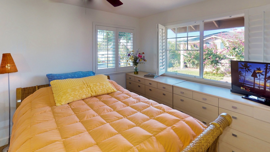 The third guest bedroom has a queen bed and large window.