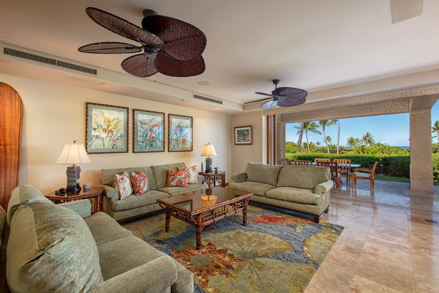 The living area with plush seating, TV, ceiling fan and central AC.