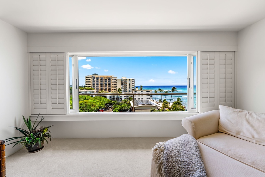 Natural light pours into the primary room, where comfort meets incredible Waikiki views.