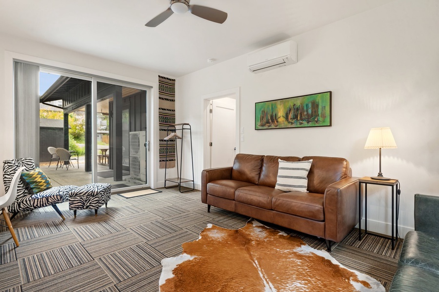 Open-concept living room with large windows and comfy seating—designed for connection and calm.